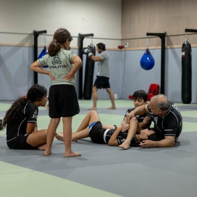 Kids practicing mixed martial arts drills combining striking and grappling in Allen, Texas.
